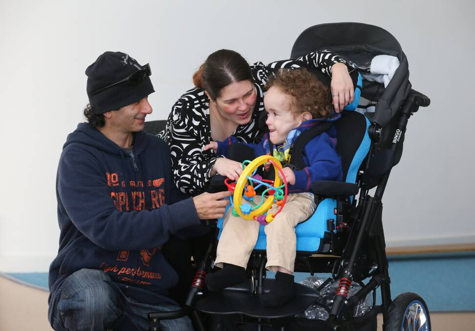 WHEELIE GOOD: Denis Ingram and Anne-Maree Pengelly with their son Lucas Ingram, 1, who is enjoying the ride in his new stroller with a specialised seating system.