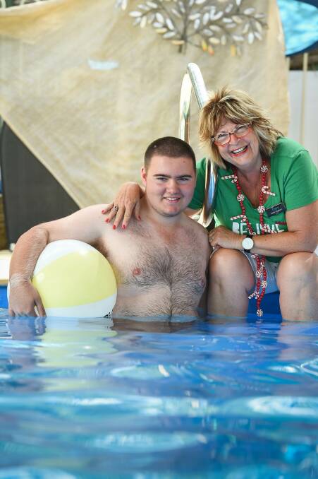 MAKING A SPLASH: Nathan Pearce, pictured with Aspire board director Lizzie Pogson, before his departure for Abu Dhabi to compete at the World Games Special Olympics. Picture: MARK JESSER