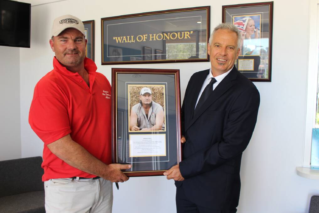 LIFETIME HONOUR: Burrumbuttock Hay Runners founder Brendan Farrell is presented with his Wall Of Honour award by Murray High School's Maurice Woodman.