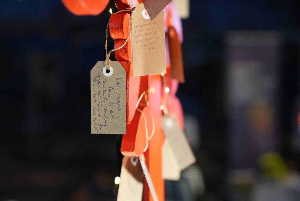 LOVE LIVES HERE: Handshakes, hugs and hand-written notes on a red tree.
