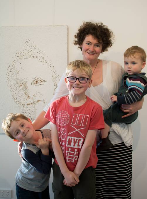 CREATIVE HEALING: Melissa Lubke with sons Archer, 7, Jezeriah, 9, and Jonathan, 3, with the portrait of her late husband Andrew, of Henty, is facilitating the weekend.