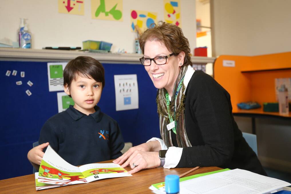 LEARNING FOR LIFE: Albury's Aspect School student Hunter Hayes, 7, with Sally Disher - the school has received a $10,000 grant for a literacy program. Picture: JAMES WILTSHIRE