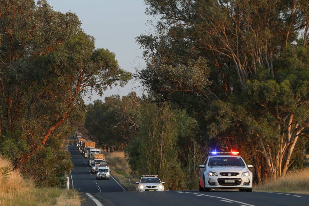 ON THE ROAD: While there is no "formal police escort" for the hay runners, Albury Highway Patrol officers were there to see the convoy on its way Friday morning. Picture: JAMES WILTSHIRE