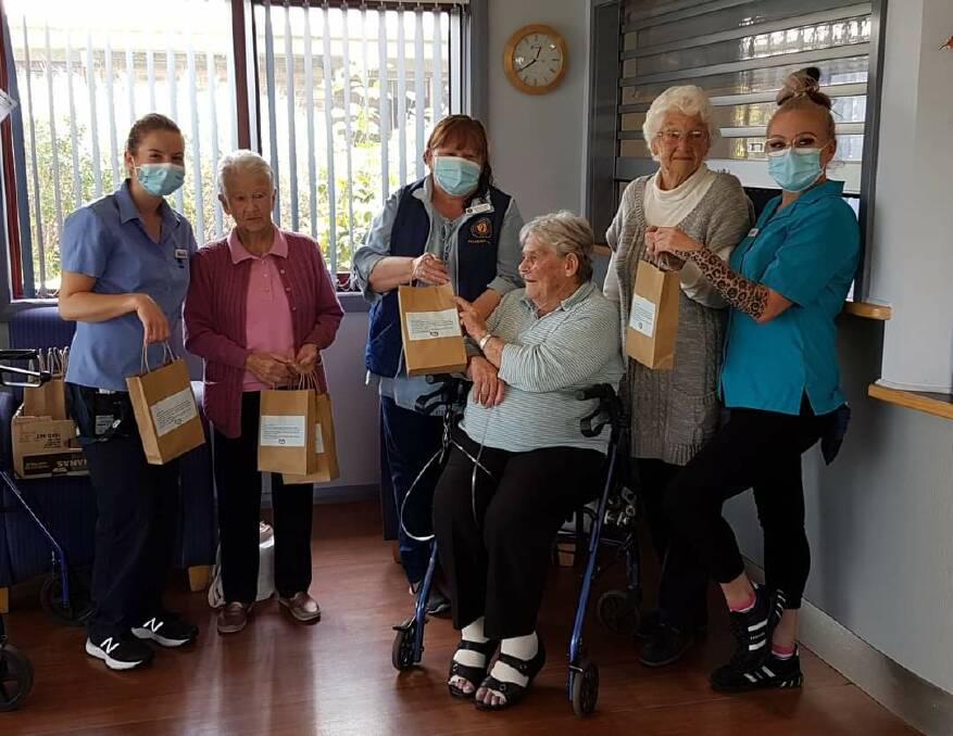 PACKED WITH LOVE: Nett Maloney (centre) delivers care bags to UPA's Murray Vale Residential Aged Care Facility, Lavington. Picture: SUPPLIED
