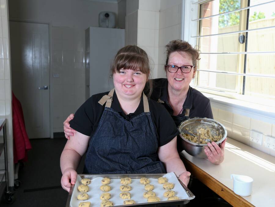 OVEN FRESH: Purple Chicken participant Shania Bryant brushes up on her baking with founder Jen Tait ahead of the fire fundraiser cake stall. Picture: TARA TREWHELLA