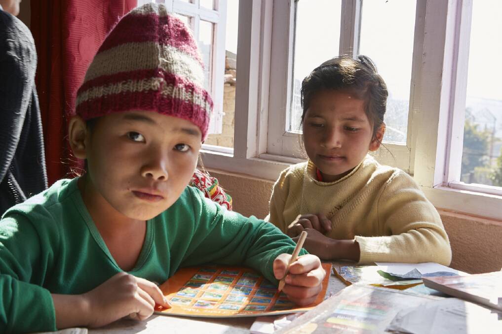 NO PLACE LIKE HOME: Siblings Anita and Manoj Tamang completing their homework at Noble House after the death of their father and with their mother living in a remote part of Nepal, unable to care for them.