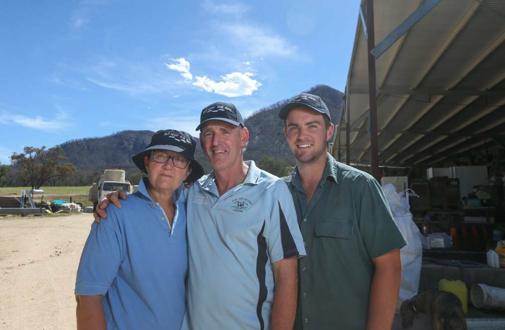 KEEPING ON: Elise and James Hill, and their son Jake, wearing hats bearing Sam Hill's name at their Cudgewa property. Picture: TARA TREWHELLA