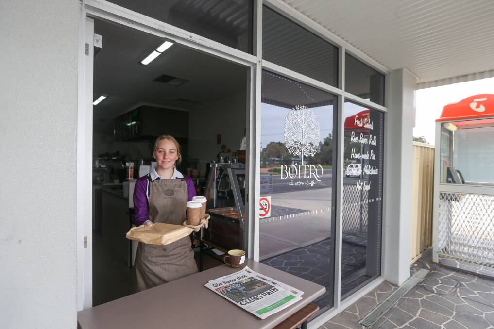 SERVICE WITH A SMILE: Next Level Cafe staff member Lara Shannon, of Jindera, serves from behind a table at the store's doorway and is planning a range of take-home family meals to expand on its services. Picture: TARA TREWHELLA