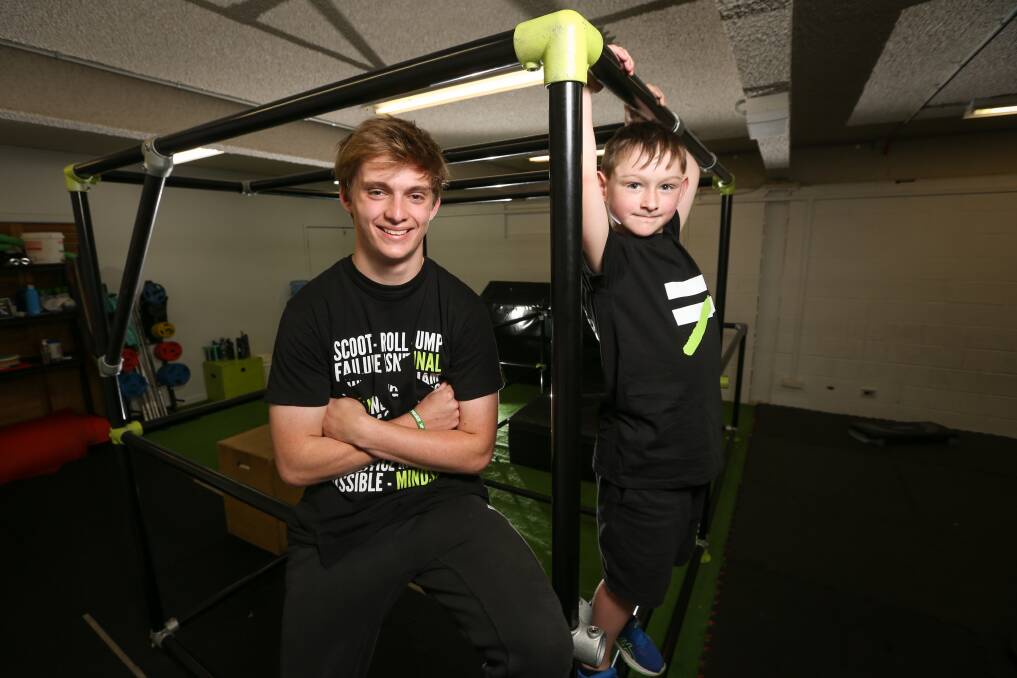 FLYING HIGH: Risky Kids coach Jorge Beavan, 17, with Kai Menzie, 8. PIcture: JAMES WILTSHIRE