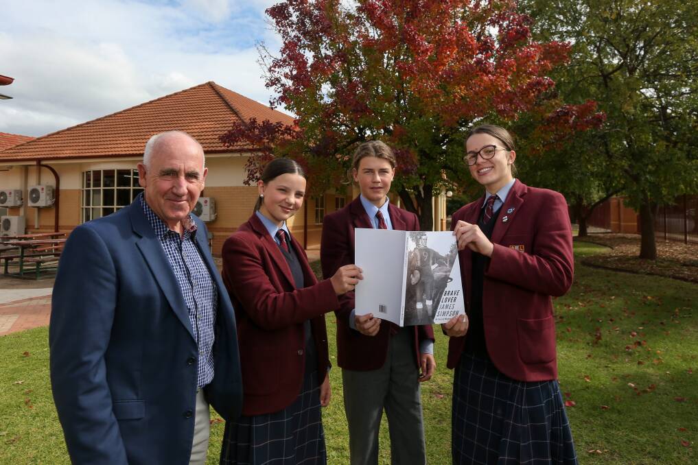 PROUD HISTORY: Author Patrick Mangan with Scots School students Freya Gniel, 14, Callum Cooper, 15, and Georgia Miller, 16 with the book detailing the life and war service of James Simpson. Picture: TARA TREWHELLA