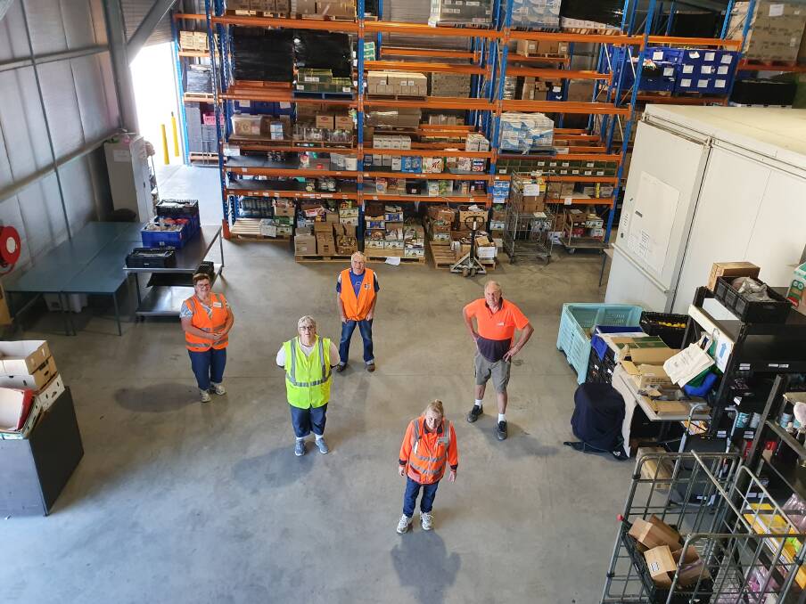 CARE - AT A DISTANCE: Albury-Wodonga Regional FoodShare volunteers practise social distancing at their busy Wodonga warehouse. Picture: SUPPLIED