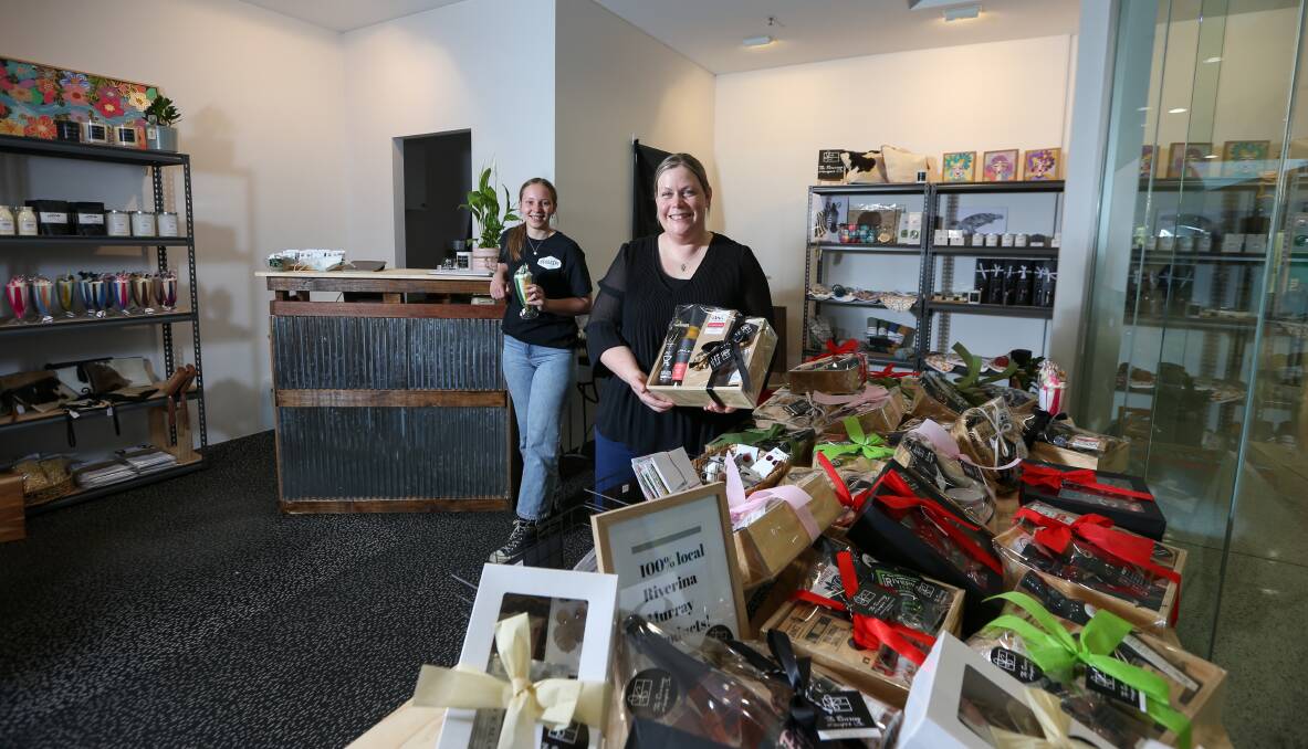 LOVIN' LOCAL: Gerogery Hotel licensee Lisa Carl has expanded her passion for local produce by opening a Riverina Hamper Co shop at Lavington Square (pictured with staff member Mia McMillan). Picture: TARA TREWHELLA