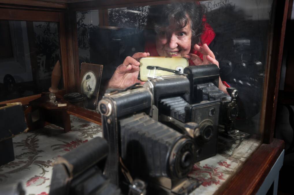 SNAPSHOT: Anne Young from Wodonga focuses on camera relics at the Jindera Pioneer Museum ahead of its 50th birthday. Picture: KYLIE ESLER