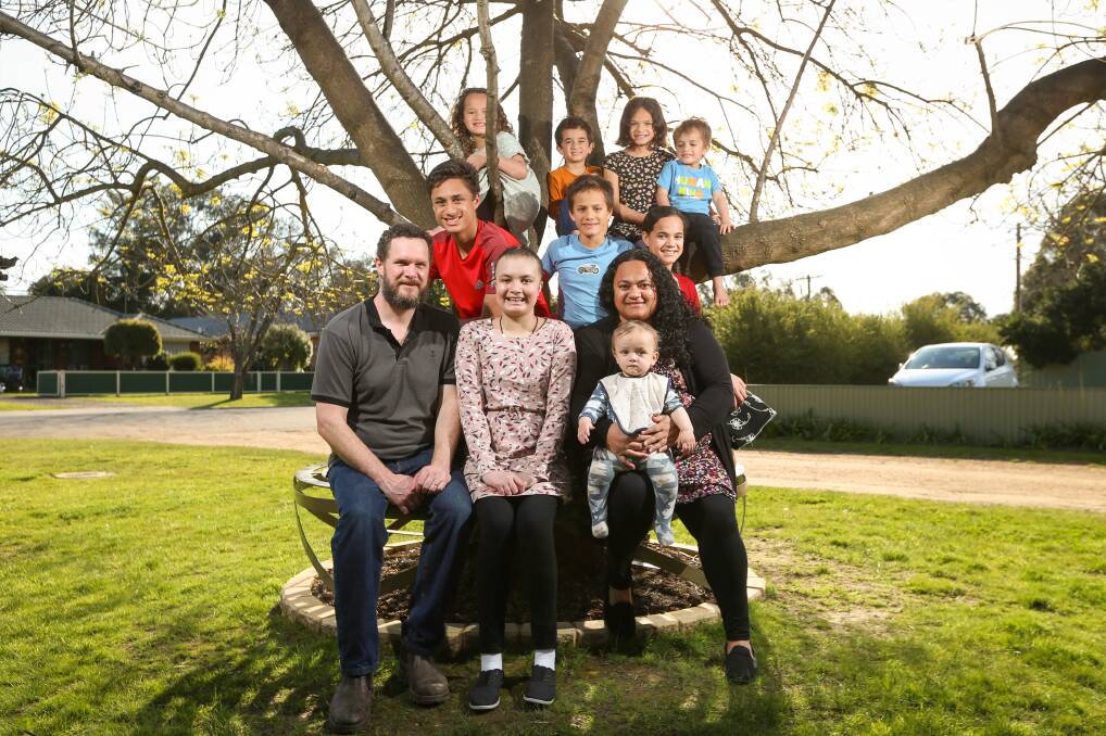 TOGETHER AGAIN: Jindera's James and Anastasia Byrnes with their nine children together again after their eldest daughter Kateri, 15, (centre) returned home on Friday after a nine-month cancer fight at Melbourne's Royal Children's Hospital. Picture: JAMES WILTSHIRE