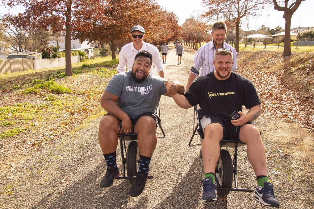 STRONG-WILLED Rahn Deuis and Mason Dannatt carry a heavy load in big men Eddie Williams and Luke Stoltman for the 2019 Share the Load challenge from Beechworth to Mount Buffalo. Pictures: SUPPLIED