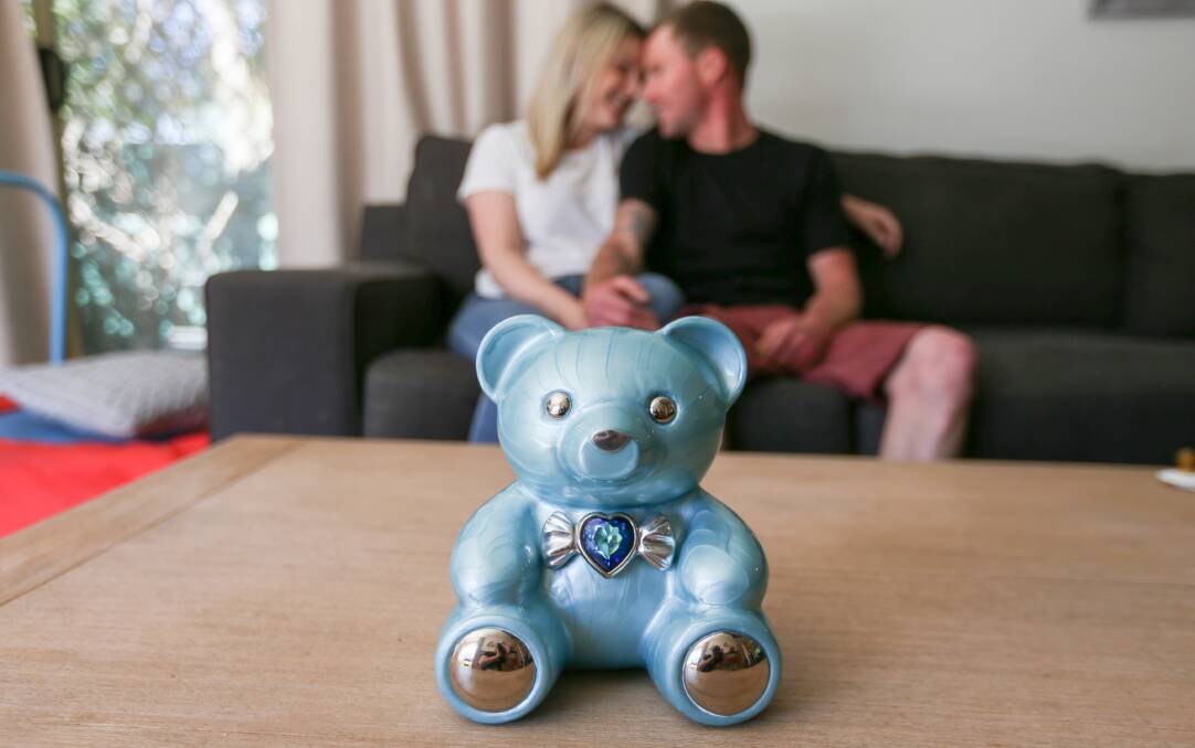 FINN'S LEGACY: Jessee Williams and Liam Butson with the ceramic teddy bear containing the ashes of Finn Gregory Butson; a fundraiser in his name has secured a cuddle cot to support other bereaved families. Picture: TARA TREWHELLA