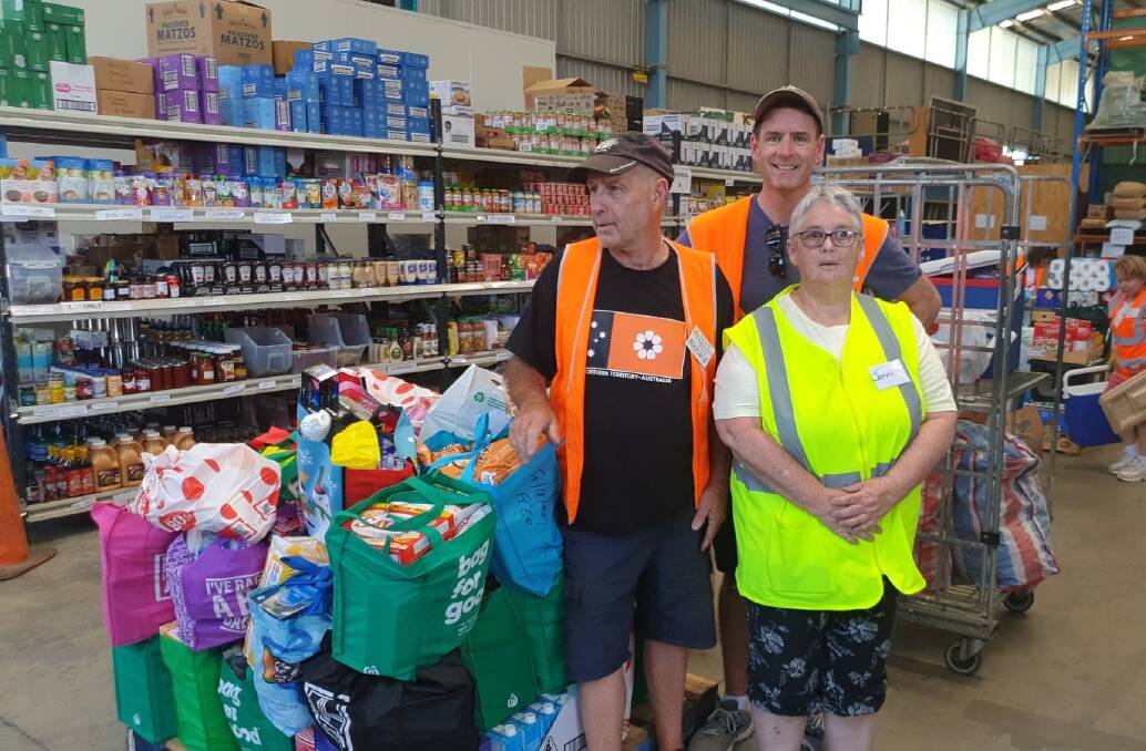 TIRELESS: Albury-Wodonga Regional FoodShare's Richard Robertson, Simon Welsh and Jenni Sceriha were part of the team organising food aid during the bushfires.