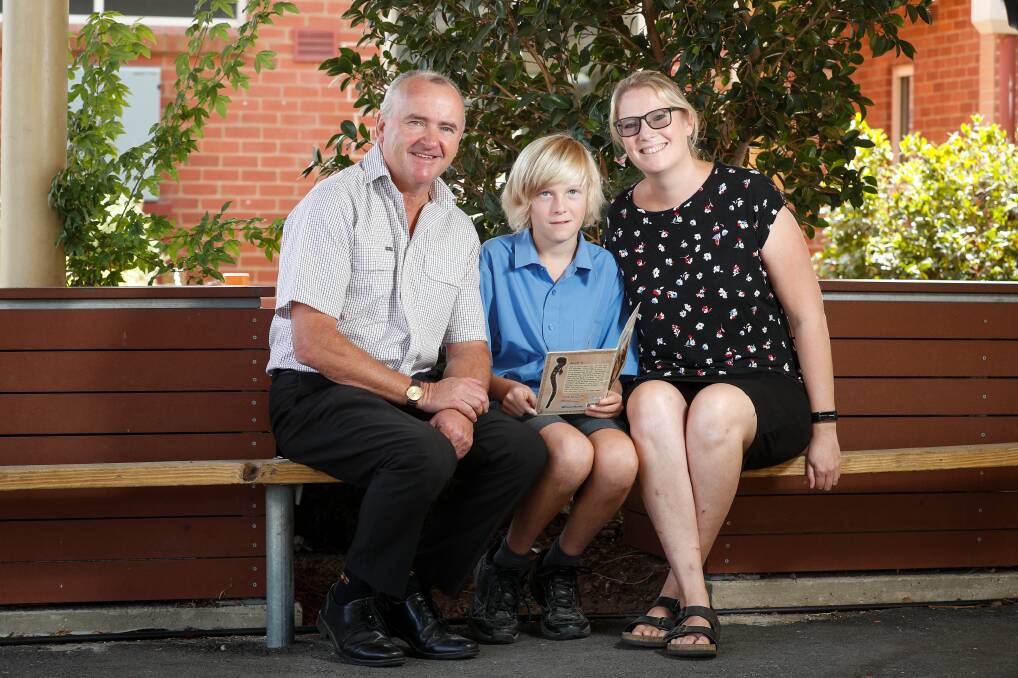 WELL-READ: St Augustine's Wodonga principal Joe Quinn with Year 6 student Zack McPherson and his mum Jennifer. Picture: JAMES WILTSHIRE