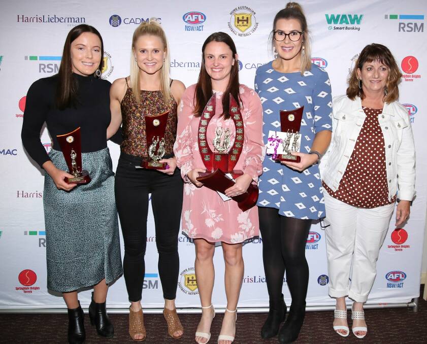 Outgoing president Julianne Clancy (right) with this year's A-grade best and fairest wirners.