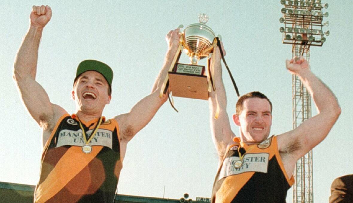 Glenn Page and coach Michael Buchanan celebrate the 1997 premiership.