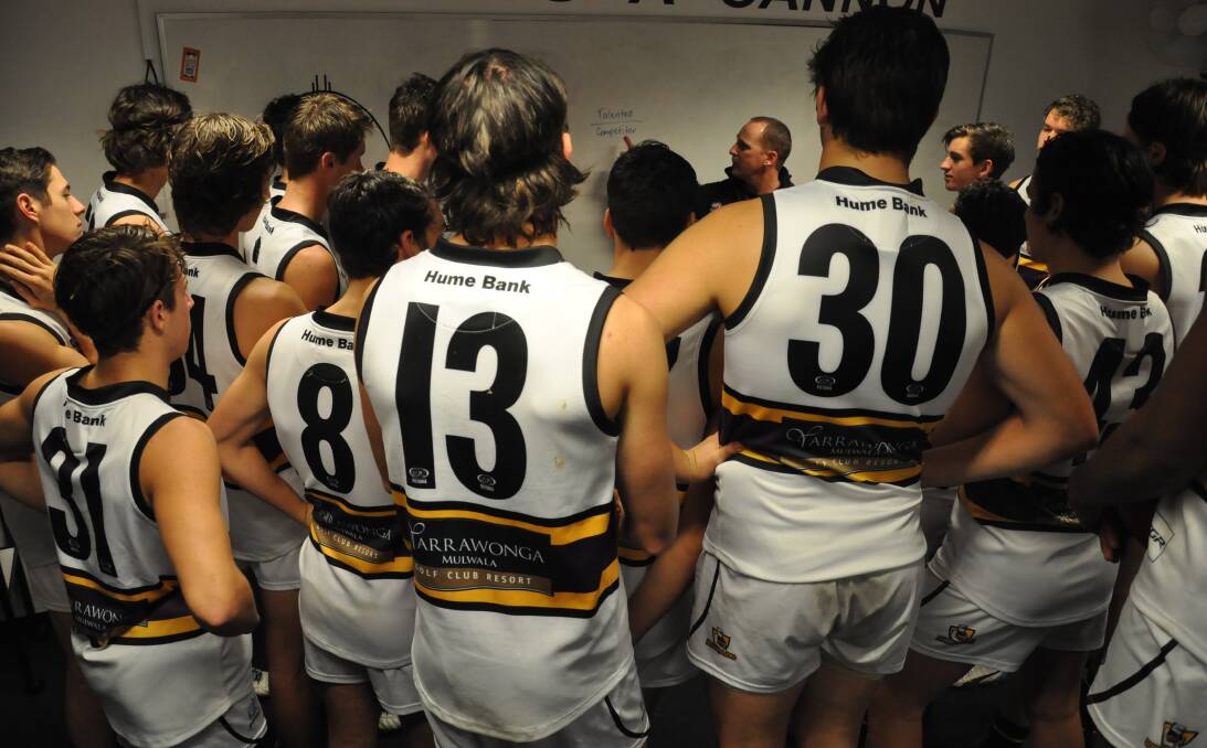 Murray Bushrangers coach Leon Higgins talks tactics with his players before taking on Geelong Falcons. The Bushies are sitting in fourth position on the ladder.