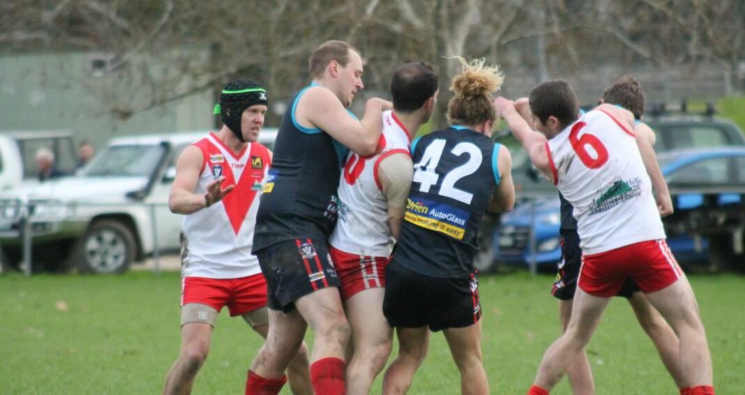 Federal and Corryong players tangle during their clash at Corryong. The Swans ran-out comfortable victors.