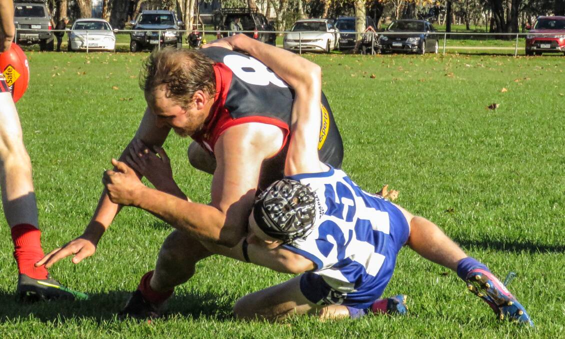Tumbarumba youngster Darcy Rixon brings down Corryong's Thomas Nicholas. Picture: WENDY LAVIS