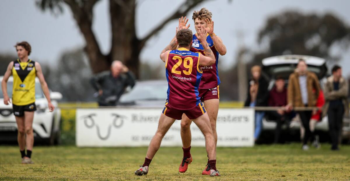 Brothers Nick and Sam Murray celebrate a goal during the Lions' 26-point victory over Osborne at Osborne on Saturday. Picture: JAMES WILTSHIRE