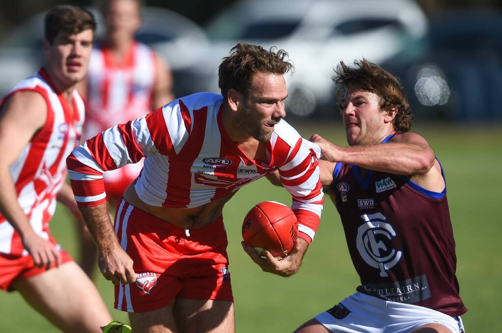 Henty's Jared Brennan busts a tackle from Culcairn's Jye Shields last season. The star Swampie will leave a gaping hole in the club's midfield.