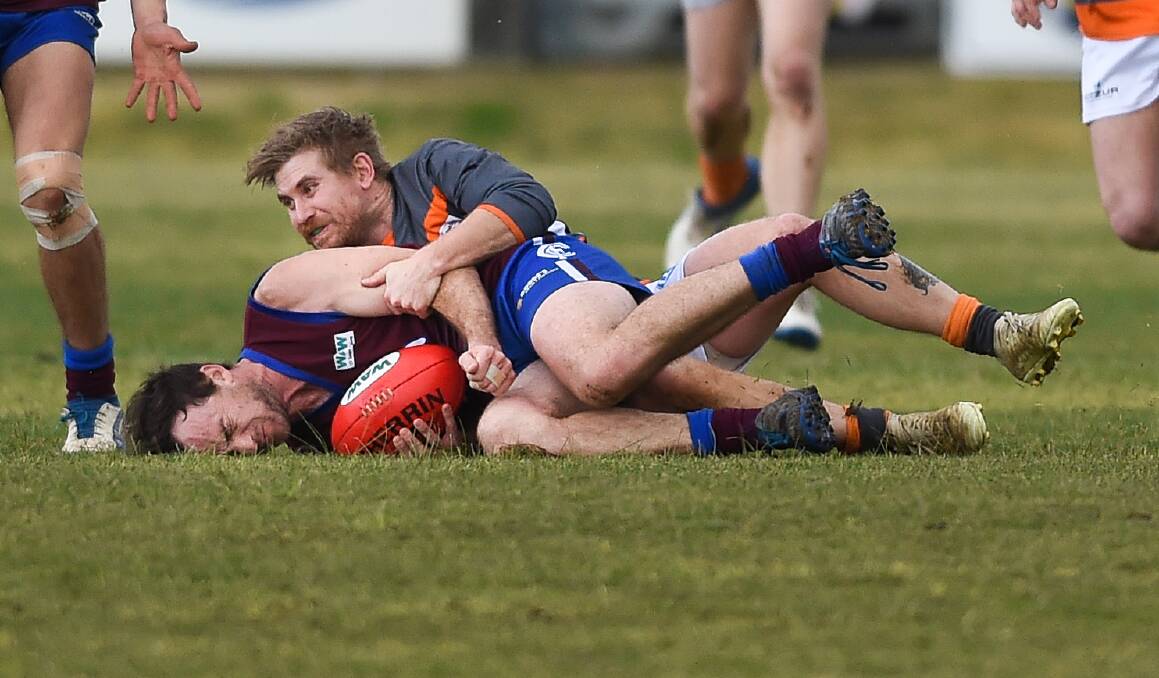Culcairn's Nate Stroh is buried in a tackle by Giant Jarryd Weeding.