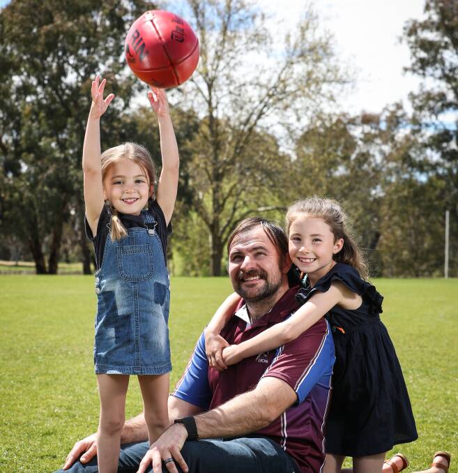 HAVING A BALL: New Culcairn coach Josh Hillary with his daughters Lola and Evie. He joins the Lions from Jerilderie. Picture: JAMES WILTSHIRE