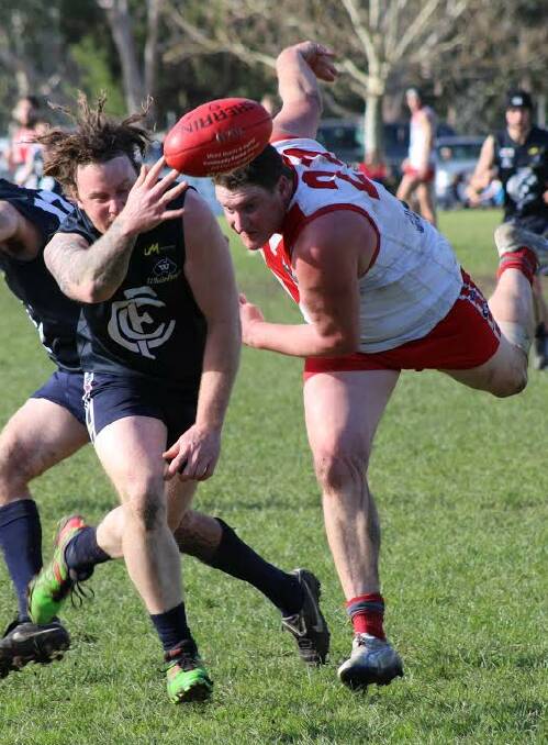 UNDER THE PUMP: Cudgewa's Kieran Lawrence feels the pressure from big Federal forward Brent Ohlin in the preliminary final at Corryong on Saturday. Picture: CORRYONG COURIER