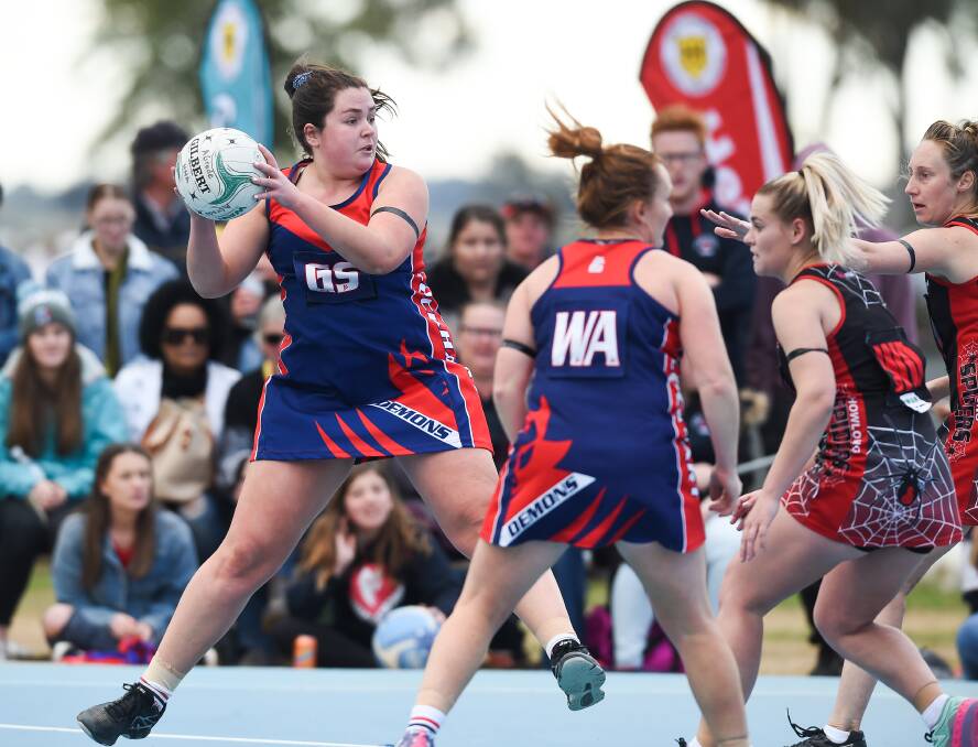 Lockhart's Isabella Smyth looks for a teammate during the Demons' narrow victory. They will now take on Murray Magpies.