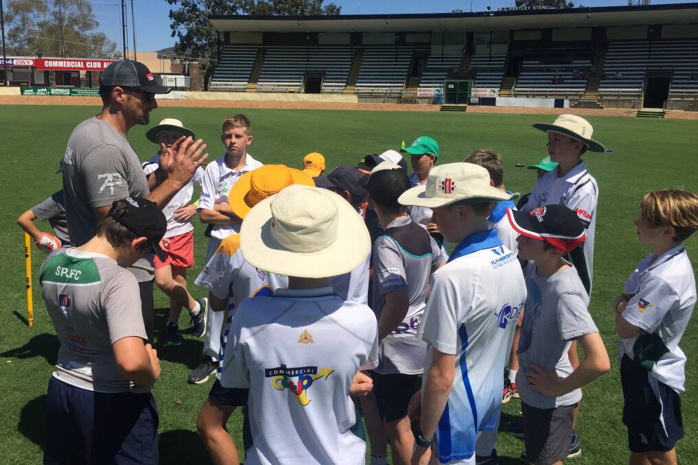 ALL IN: CAW under-12 coach Aaron West talks to his squad during trials at Lavington Sportsground on Thursday. The age group has been introduced for the first time with matches to be played under new Cricket Australia guidelines.