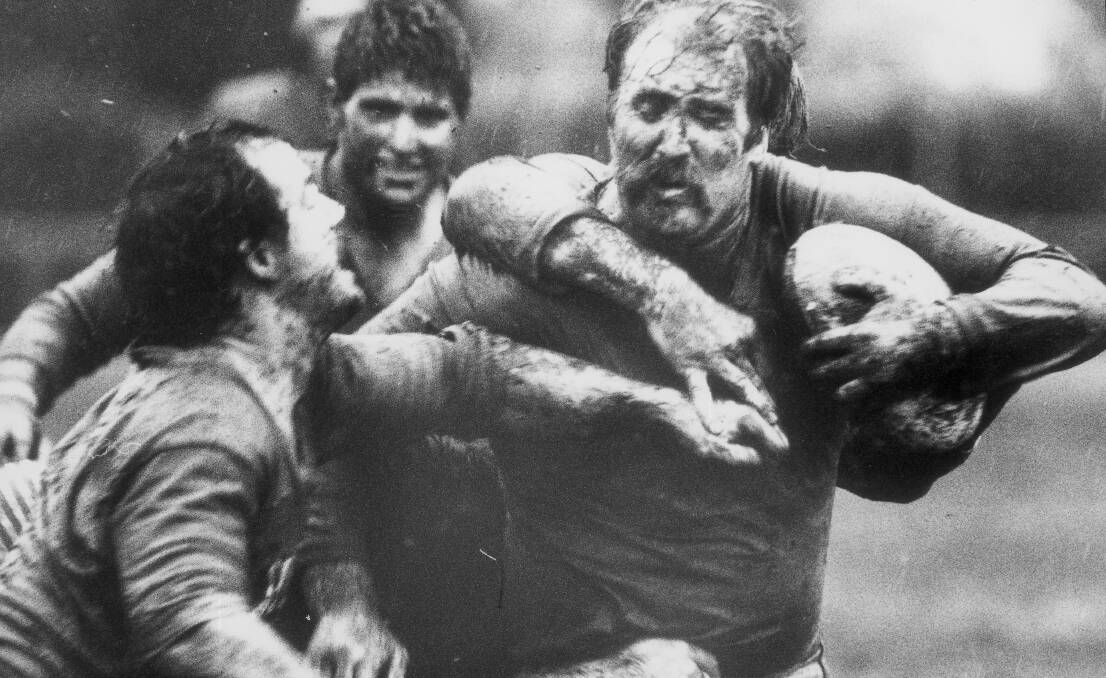 Garry Purtell busts a tackle playing for his beloved Albury Blues. He coached the club to a premiership.