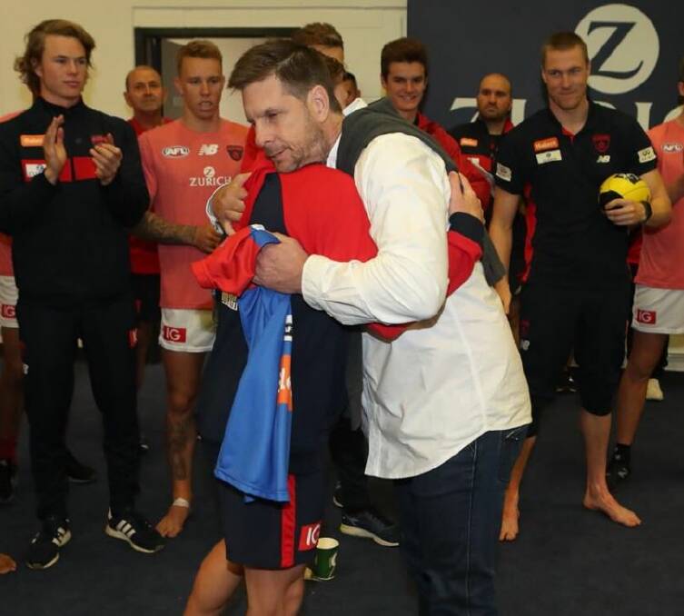 Paul Spargo congratulates his son, Charlie, on making his debut before Melbourne's clash with Essendon at Etihad Stadium. Charlie kicked two goals in an impressive first-up performance.