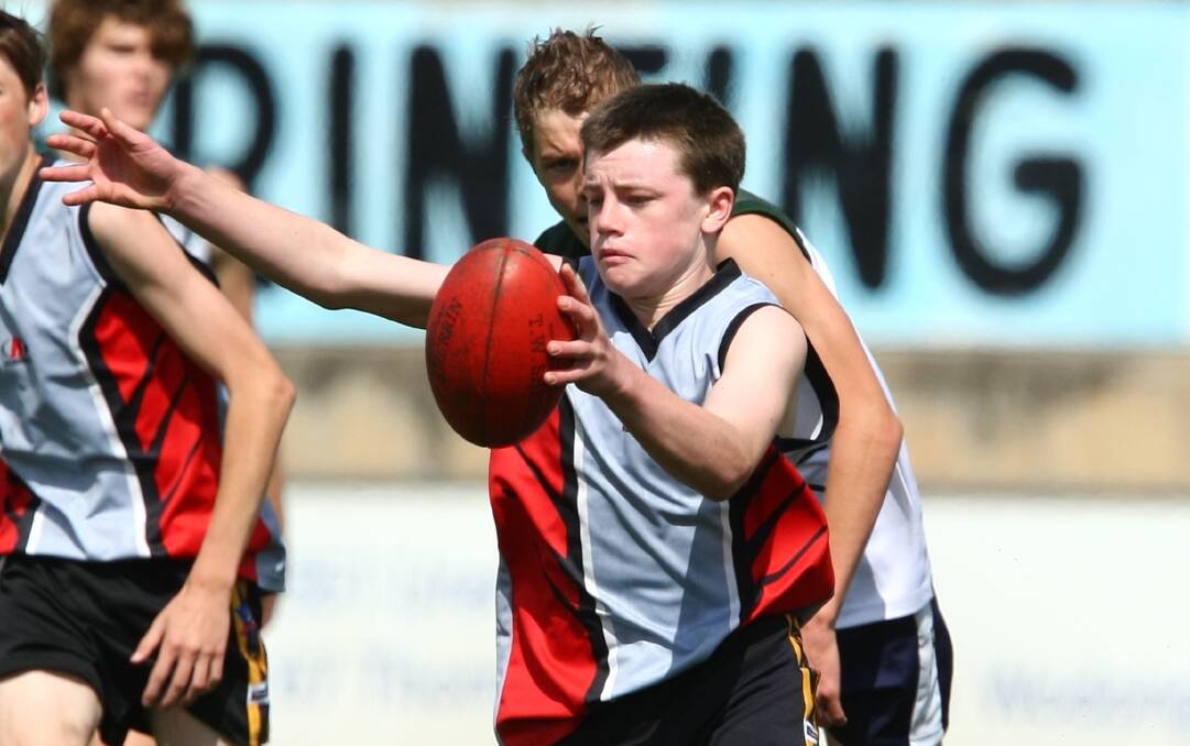 Dom Brew gets a kick away for Albury High against Finley High School in the Swan Shield in 2011. Brew went on to be vice-captain of his school.