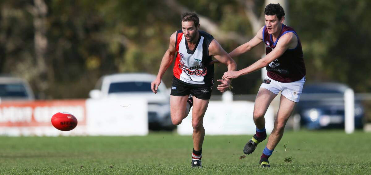 Brock-Burrum's Kade Garland leads Lion Trent Logue to the ball on Saturday. The Saints ran-out comfortable victors. Picture: TARA TREWHELLA
