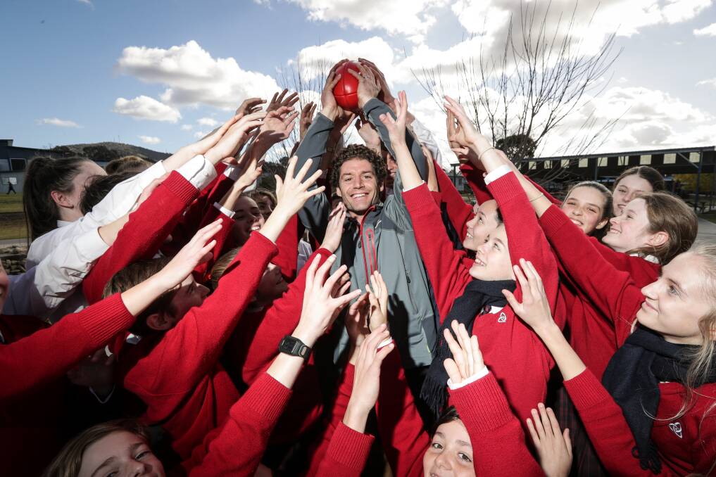 North Albury captain David Miles is swamped by Trinity Anglican College students. Picture: JAMES WILTSHIRE