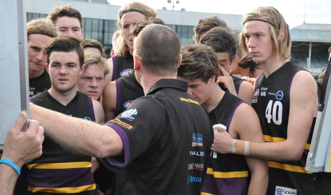 Murray Bushrangers coach Leon Higgins talks tactics with his players at quarter-time during Saturday's preliminary final in Melbourne.