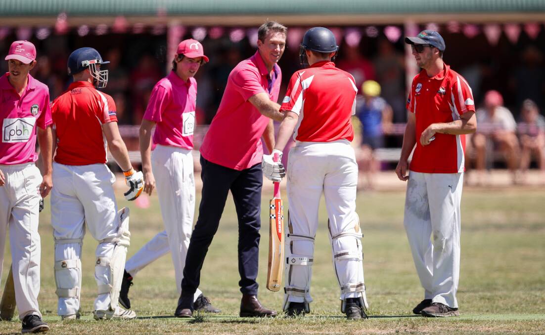 Glenn McGrath shakes hands with Henty's Tom Newton after sending down an over at Walbundrie on Sunday. He finished with figures of 0-1. Pictures: JAMES WILTSHIRE