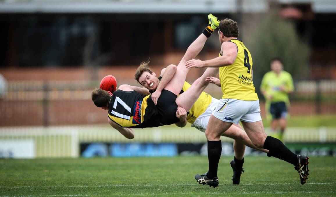 Jim Grills is nailed in a tackle by Osborne's Will Ryan at Wagga on Saturday.
Picture: JAMES WILTSIRE