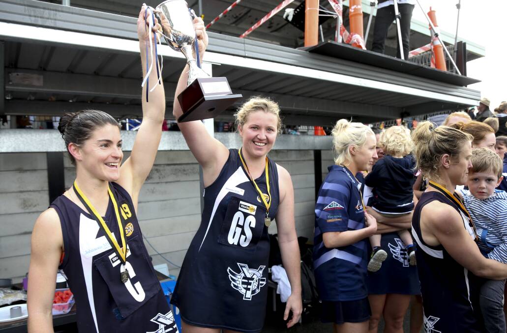 Laura Bourke and Bridget Cassar celebrate Yarrawonga's premiership last season. Cassar has played in seven fags for the Pigeons.