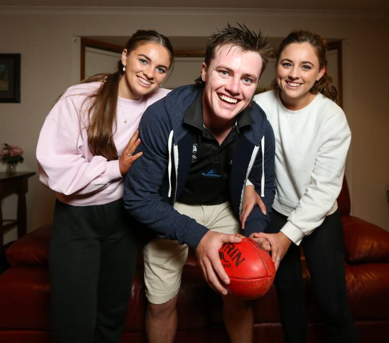 Dom Brew with his sisters Evy and Issy. The Nightcliff star romped to victory in the NT league medal on Sunday.