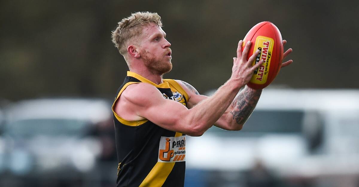 Four-time Barton medallist Cameron McNeill marks for Barnawartha at Sandy Creek on Saturday. He kicked one goal for the Tigers.