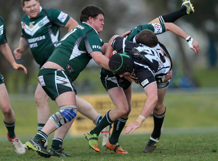 Greens' Zachary Richards and Shane Peel get the better of Daniel Webb in a tackle. A big crowd turned out for the match.