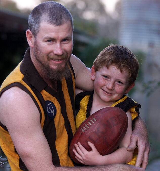 Barber with his son, Jacob, before his 300th match for the Hawks in 2002.