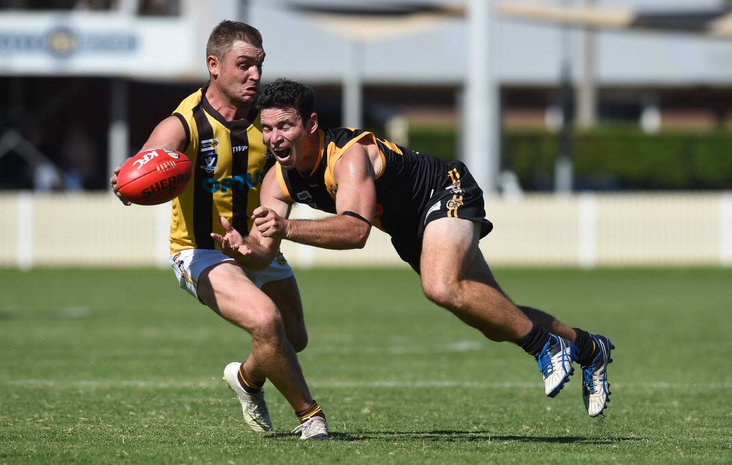 GOING STRONG: Sam Carpenter evades a tackle from Albury's Luke Packer during the Ovens and Murray season.