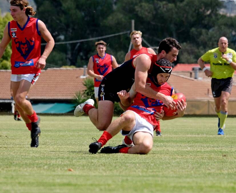 Wodonga Raiders defender Lachie Flagg tackles a Shepparton United player during Saturday's pre-season clash in Wodonga. The home team surged clear after quarter-time to win comfortably. Picture: JANICE NEWNHAM