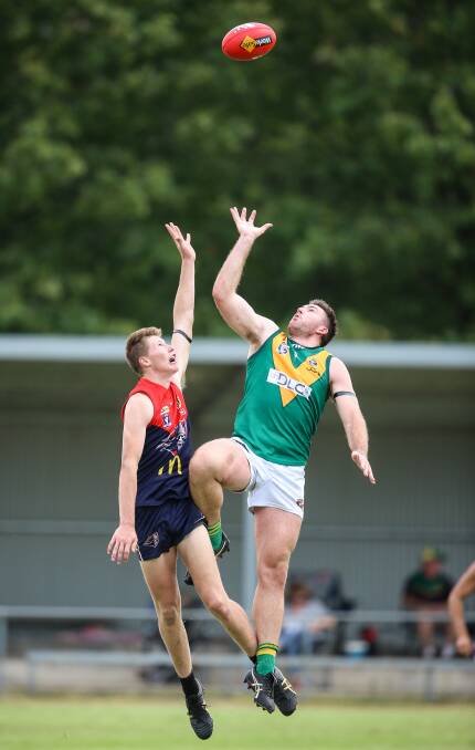 Young Raider ruckman Sasha Newnham and North Albury coach Isaac Muller do battle at Sandy Creek on Saturday. Picture: JAMES WILTSHIRE